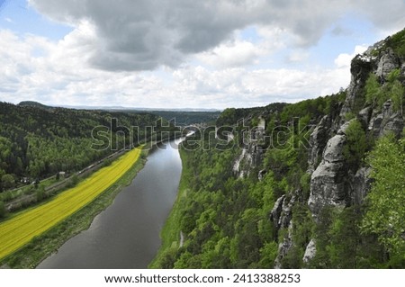 Landscape with river and riverbanks, nature and city