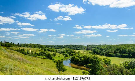 Landscape with a river, whose banks are covered with dense vegetation - Shutterstock ID 1124296775