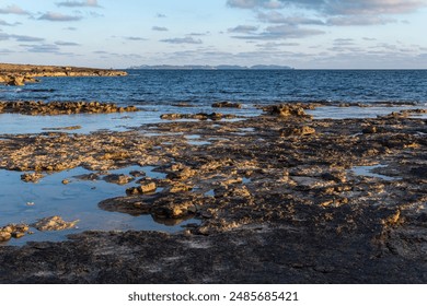 Landscape of the rocky coast of the island of Mallorca with the island of Cabrera in the background at sunset. Spain - Powered by Shutterstock