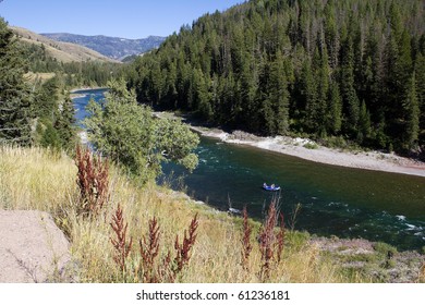 Landscape With Rubber Raft Floating The Snake River Rapids Near Grand Teton National Park In Wyoming.