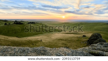 Landscape of Russian Dauria steppe with hills under sunset