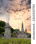 Landscape of the sanctuary of Our Lady in Lourdes at sunset, France -  Religious tourism concept
