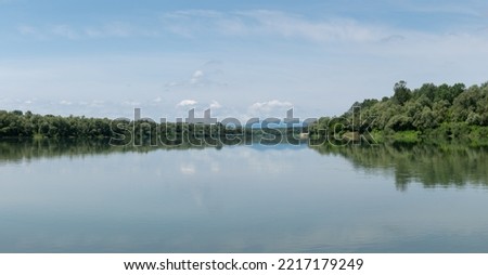 Landscape of Sava river and distant mountain Motajica silhouette in haze, during sunny summer day Stok fotoğraf © 