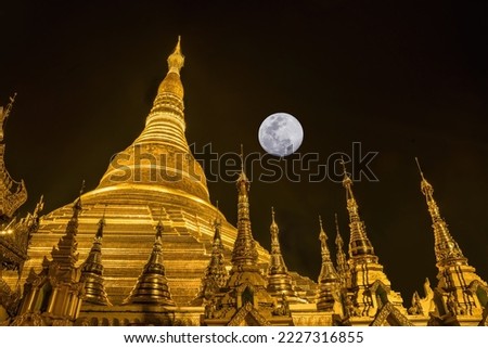 landscape scenery of golden Shwedagon pagoda and small stupa surrounding at full moon night in Yangon Myanmar sacred place and famous tourist attraction