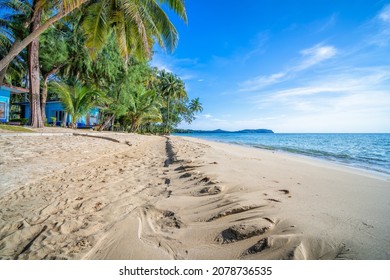 landscape scenery of sandy beack along sea with blue sky on tropical island during summer