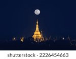 landscape scenery of Shwedagon pagoda on hill at fullmoon night famous sacred place and tourist attraction in Yangon Myanmar