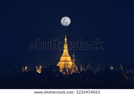 landscape scenery of Shwedagon pagoda on hill at fullmoon night famous sacred place and tourist attraction in Yangon Myanmar