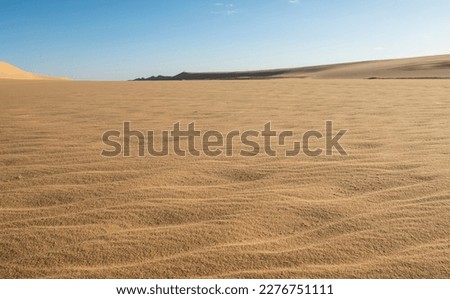 Landscape scenic view of desolate barren western desert karaween sand dunes in Egypt with blue sky background