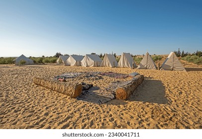 Landscape scenic view of western desert campsite in Egypt with tents camping against sunrise background - Powered by Shutterstock