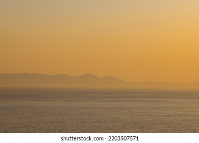 Landscape of sea, sea shore with mountains, cloudless sky at sunset and horizon. Landscape, sea and nature concept.