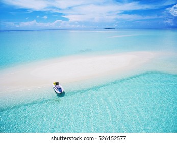 Landscape seascape aerial view over  Maldives Male Atoll sandbank island. Jet ski at the white sandy beach - Powered by Shutterstock