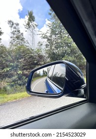 Landscape In The Sideview Mirror Of A Car , On Road Countryside.