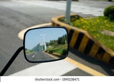 Landscape In The Sideview Mirror Of A Motorcycle