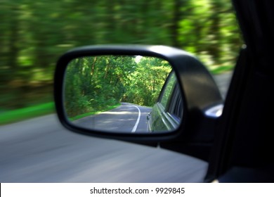 Landscape In The Sideview Mirror Of A Speeding Car