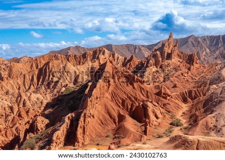 Landscape of Skazka canyon on Issyk-Kul lake. Rocks Fairy Tale famous destination in Kyrgyzstan. Mountain like great wall of china and Rainbow Mountains of Danxia or Antelope crevice USA. Central Asia