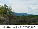 landscape with sky and clouds.green pine trees in the mountains. beautiful view from the top of the mountain on summer day. blue sky over green hills