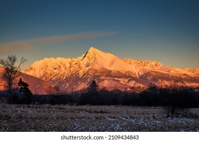 Landscape of snowy mountain peak at sunset. View of Krivan Peak, the highest peak of the High Tatras National Park, Slovakia, Europe.