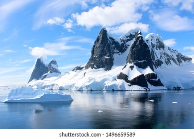 Landscape of snowy mountains and icebergs of the Lemaire Channel in the Antarctic Peninsula, Antarctica