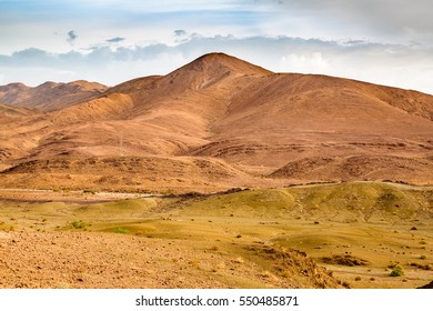 Landscape of southern Morocco is characterized by mountains, plains, stony soil, sand and meager vegetation. - Shutterstock ID 550485871