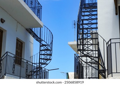 A landscape with a spiral staircase that shines against the blue sky - Powered by Shutterstock