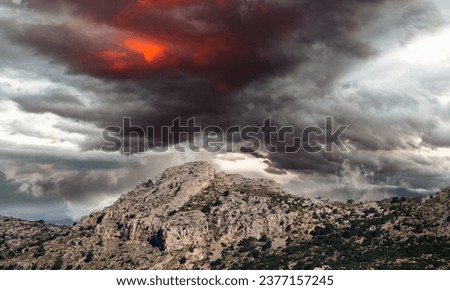 landscape with stormy clouds over the mountain peak