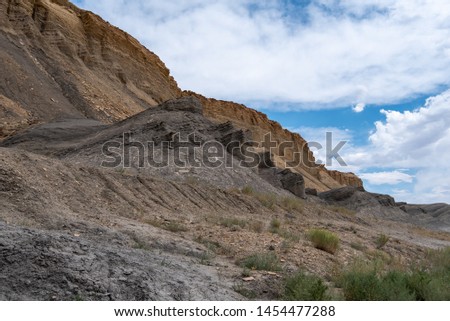 Landscape of strange grey and yellow rock formations or hills near Hanksville, Utah