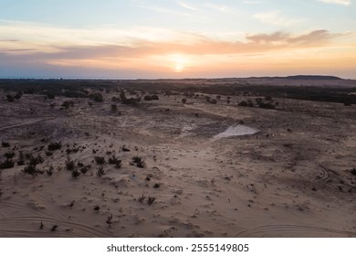 Landscape of sun over skyline in desert at White Sand Dunes Mui Ne, Vietnam. Countryside panorama under scenic colorful sky at sunset dawn sunrise. Beautiful view of bright dramatic sky dark ground - Powered by Shutterstock