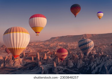 Landscape sunrise in Cappadocia with colorful hot air balloon fly in sky over deep canyons, valleys. Concept banner travel Goreme Turkey. - Powered by Shutterstock