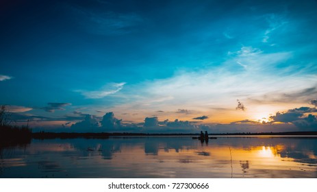 Landscape Sunset With Blue Sky Over Lake Backgrounds And Silhouette Mature Couple Fishing