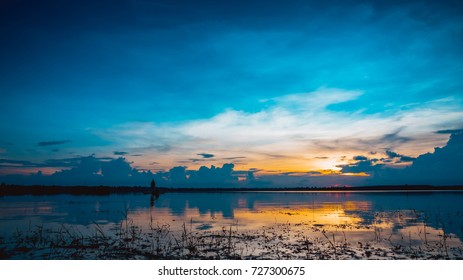 Landscape Sunset With Blue Sky Over Lake Backgrounds And Silhouette Mature Couple Fishing