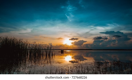 Landscape Sunset With Blue Sky Over Lake Backgrounds And Silhouette Mature Couple Fishing