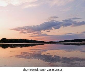 landscape in sunset lights and reflection in water - Shutterstock ID 2253528615