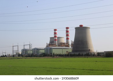 landscape of a thermoelectric power plant,  with green grass around