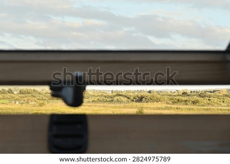 landscape through a half-open window