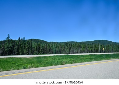 Landscape Of Trees And Mountains  From Car In Northern Quebec