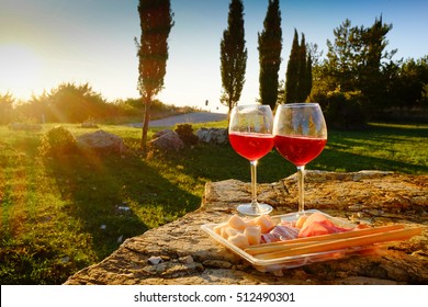 Landscape of Tuscany and two glasses of wine  