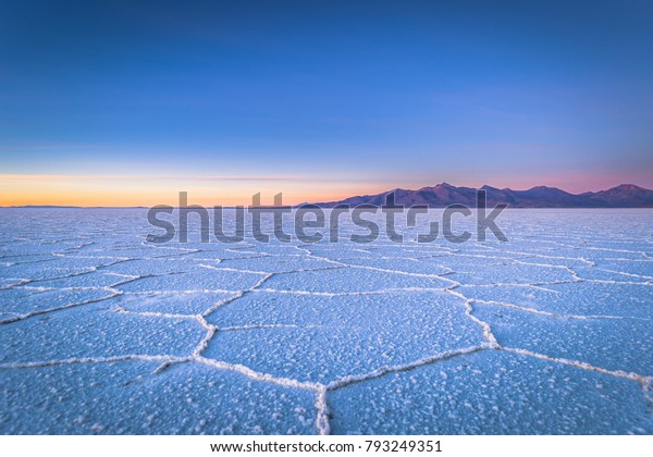 Landscape of\
the Uyuni Salt Flats at sunrise,\
Bolivia