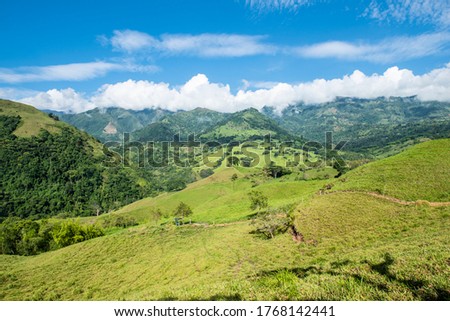 landscape with vegetation, fog and blue sky. Tamesis, Antioquia, Colombia.