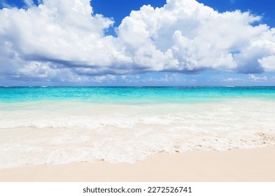 Landscape view of beautiful tropical white sand beach and turquoise sea in sunny day in Punta Cana, Dominican Republic. Empty tropical beach background. Horizon with sky and white sand - Shutterstock ID 2272526741