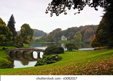 Landscape View Of An English Garden And Lake.