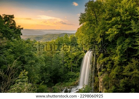 A  landscape view of Falling Spring Falls Waterfall in Virginia under sunset sky