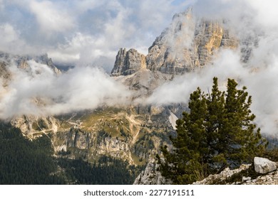 Landscape view of Falzarego Pass and Tofana di Rozes mountain from Cinque Torri. Mountain partly hidden by low clouds.  Beautiful rock formations in interesting cloudy weather. Dolomites, Italy. - Shutterstock ID 2277191511
