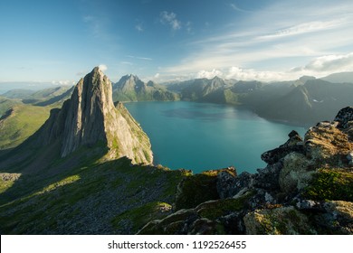 Landscape view of a fjord and mountains at sunny summer day with the village of Fjordgård down by the ocean