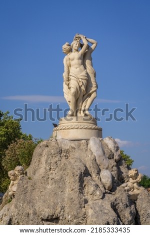 Landscape view of the fountain of the Three Graces, an elegant stone sculpture of women and angels on the famous landmark Place de la Comedie, Montpellier, France