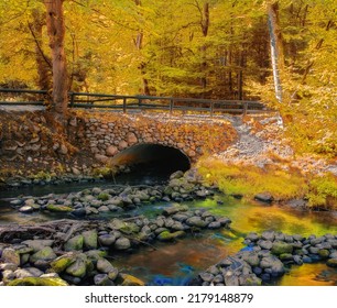 Landscape View Of A Fresh Water River Flowing Under A Cobblestone Bridge In Norway. Scenery Of Transport Infrastructure Over A Stream In A Lush Autumn Forest While Discovering A Peaceful Countryside