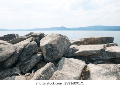 Landscape view of lake Turgoyak in summer with boulders in the foreground, South Ural, Russian Federation - Powered by Shutterstock