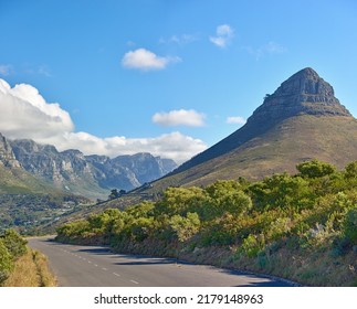 Landscape View Of Lions Head Mountain And The Twelve Apostles With Blue Sky With Copy Space In Cape Town, South Africa. Serene And Tranquil Asphalt Road In The Countryside In Natural Scenery.