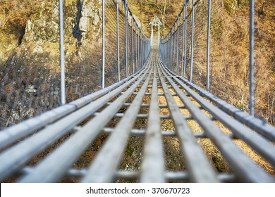 Landscape view of Long Steel Suspension bridge above the river.  Nobody 