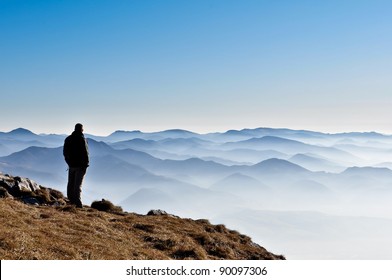 Landscape view of misty autumn mountain hills and man silhouette - Powered by Shutterstock