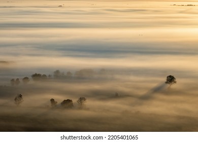 Landscape View In A Misty Sunrise